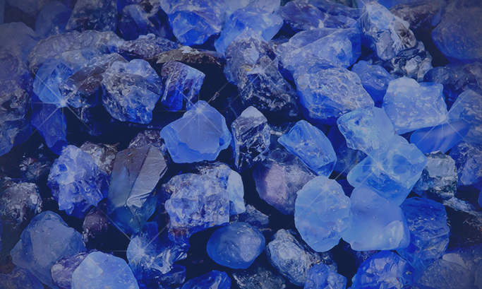 Close-up of rough Tanzanite stones on a dark background